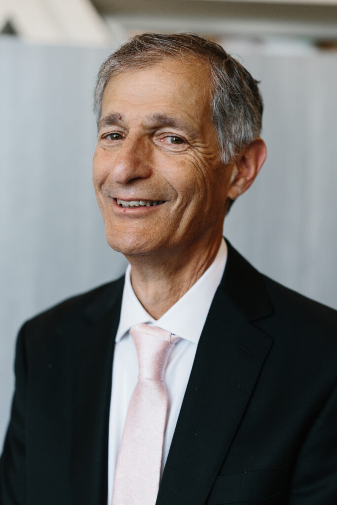 Arthur Horwitz wearing a suit, posing with members of the Detroit Jewish News Board of Directors
