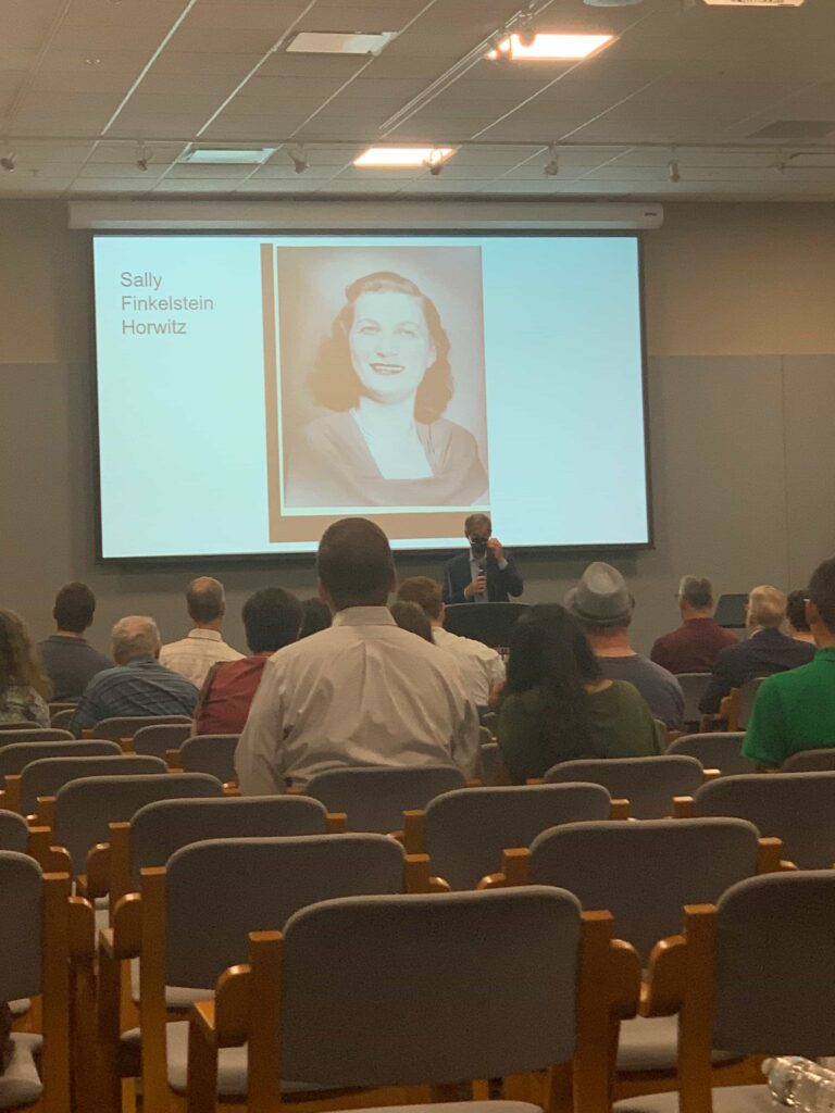 Exhibit visitors listening to survivor stories at the Zekelman Holocaust Center reopening exhibit in Farmington Hills, Michigan
